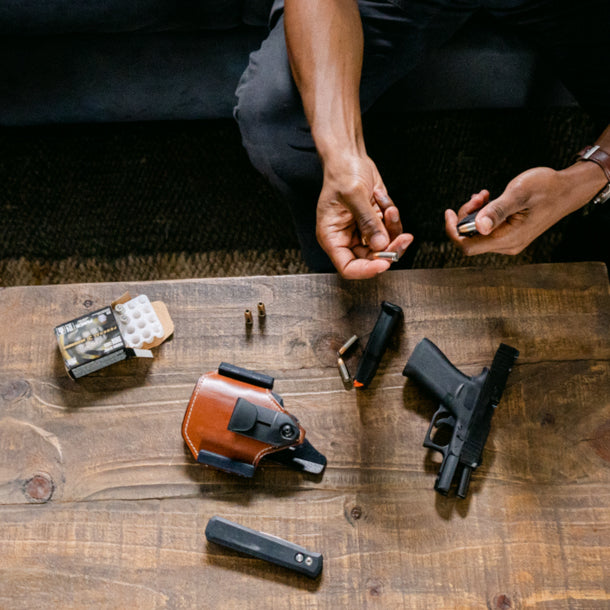 man reloading ammunition into magazine